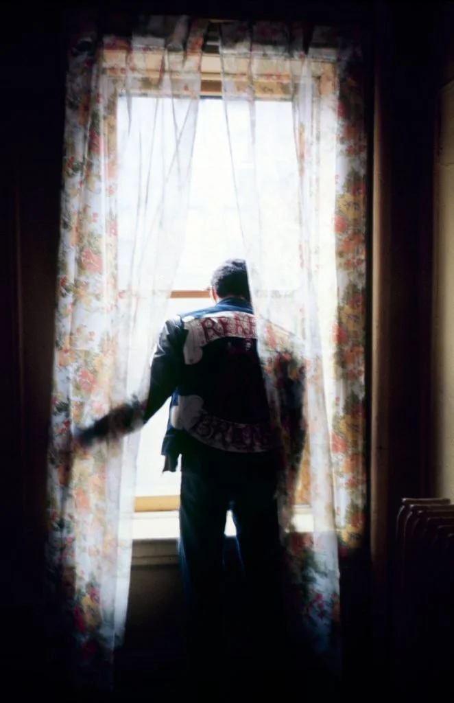 Eddie Cuevas, president of the Reapers street gang, peered out a window in the South Bronx, 1972.