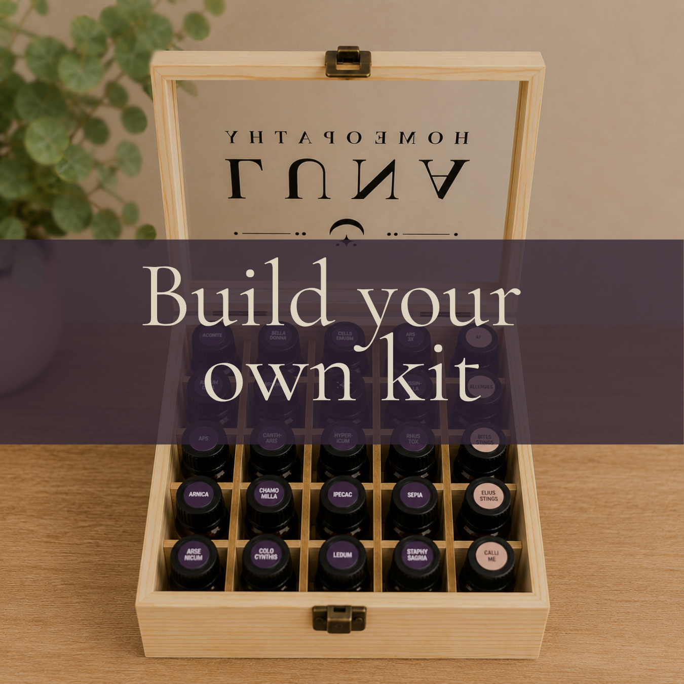 Open wooden box containing essential oil bottles with a sign on top that reads 'Build your own kit.'