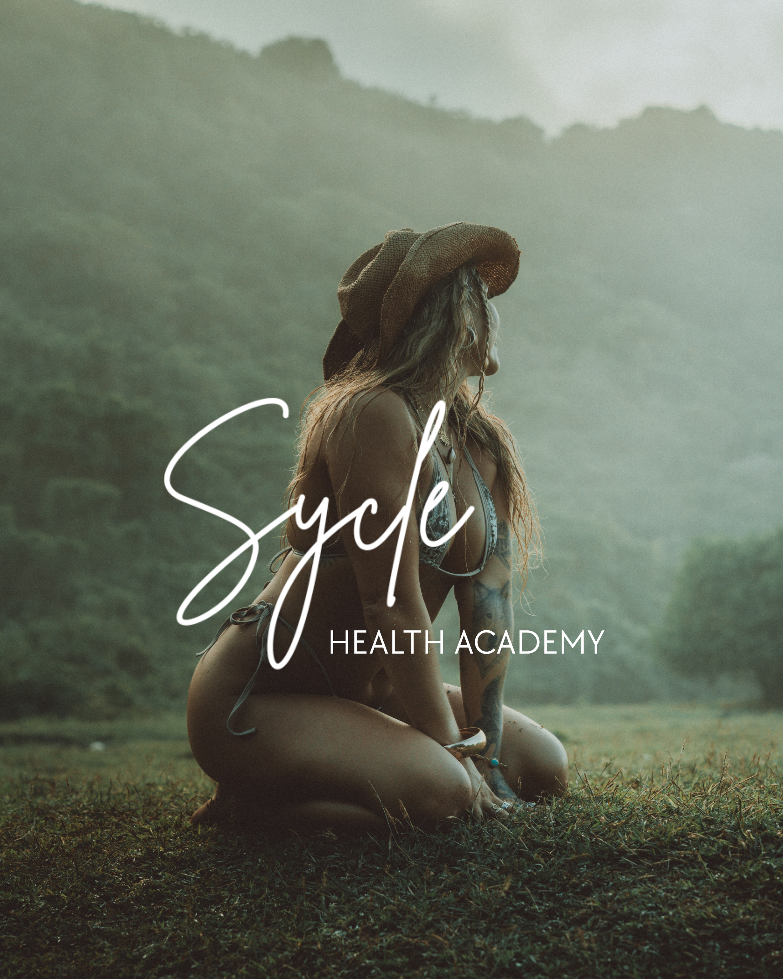 A woman with long hair, wearing a large straw hat and a bikini, is sitting on the grass in a natural outdoor setting with rolling hills in the background. The image has the text 'Cycle' and 'Health Academy' written on it.