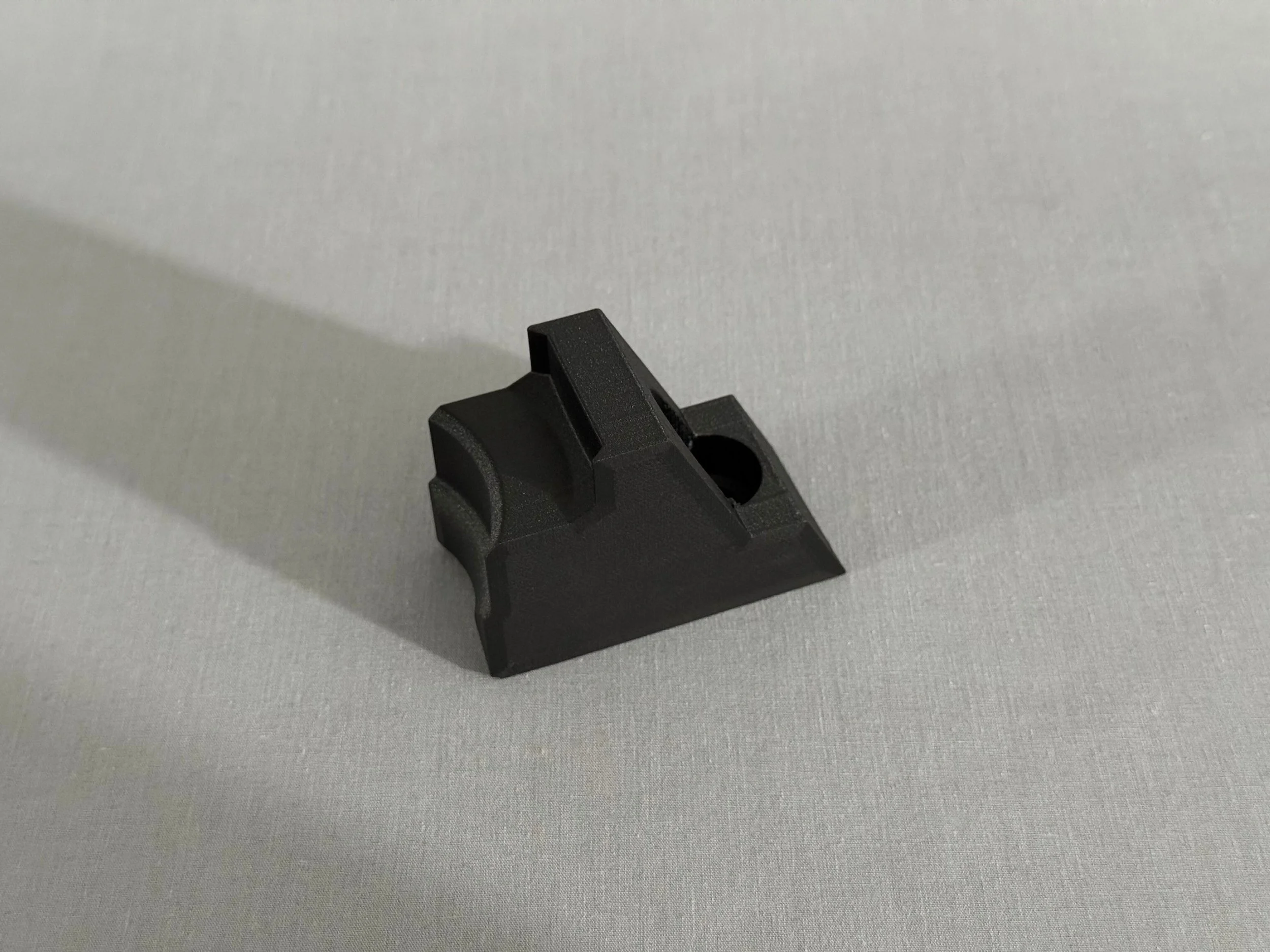 Custom 3D printed Onyx micro carbon fiber filled nylon component for industrial manufacturing.