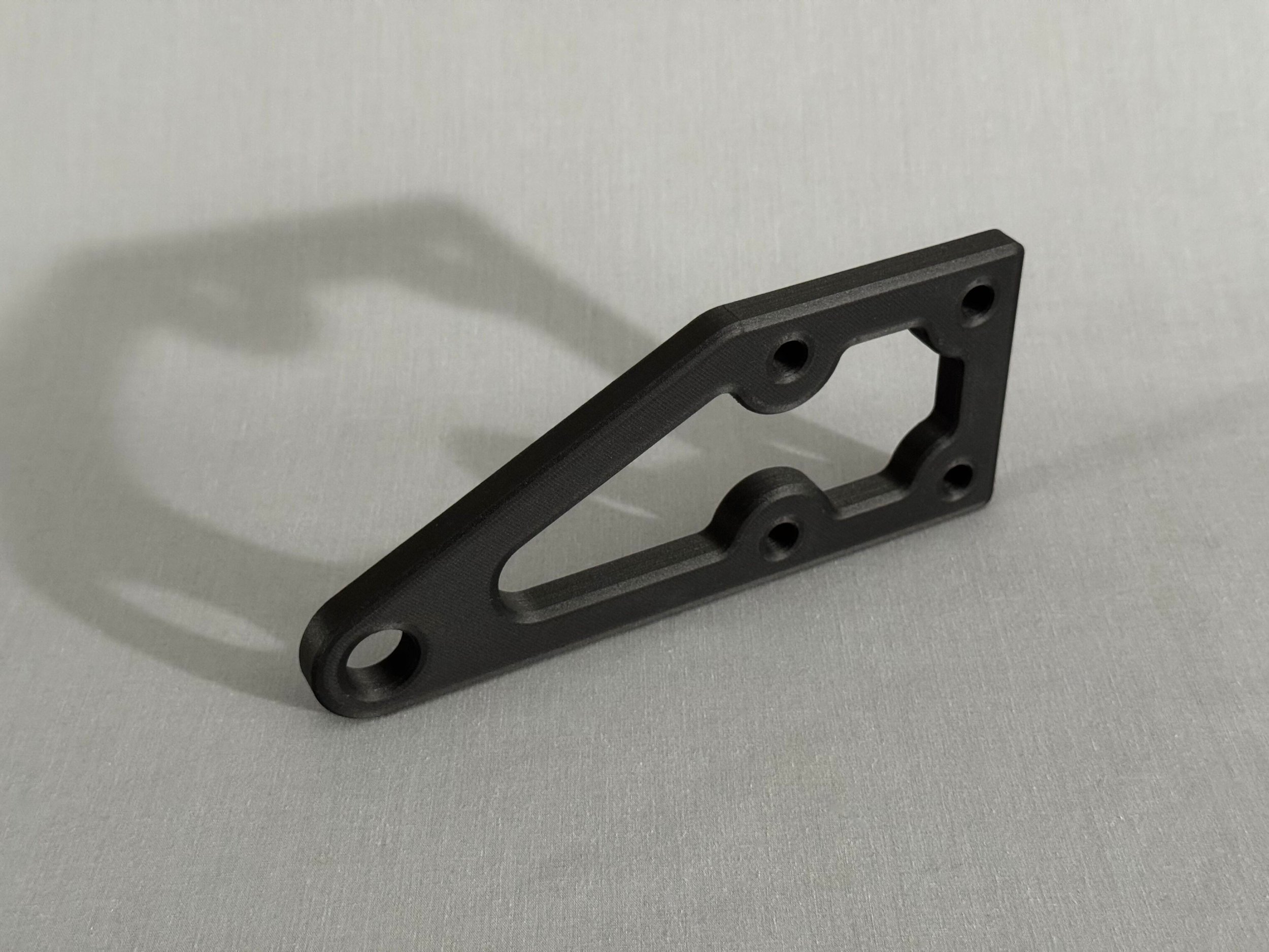 Custom continuous carbon fiber reinforced structural part.