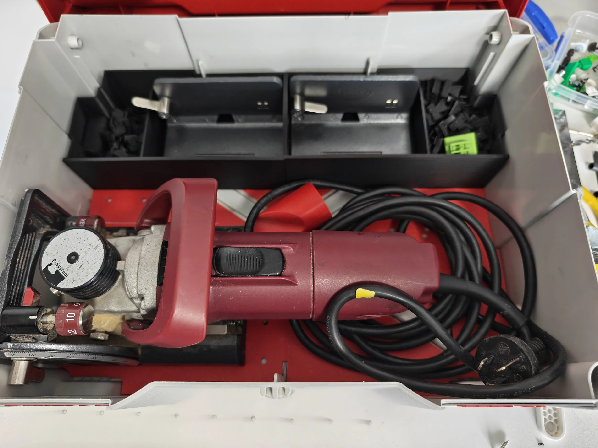 Electrical control box with black and red components, wires, and knobs, mounted inside a metal enclosure.