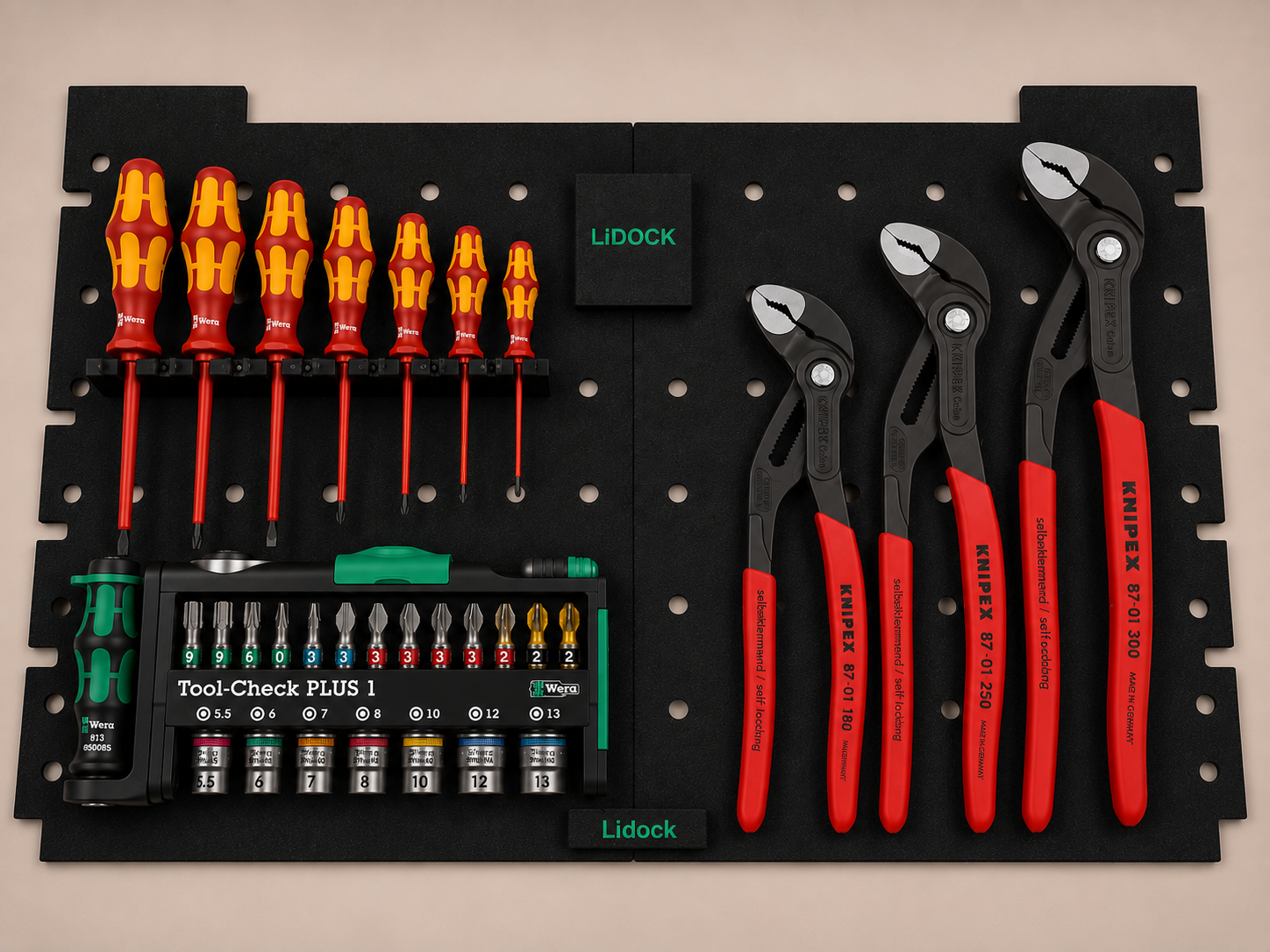 Tool organizer with screwdrivers, pliers, bits, and other hand tools displayed on a black perforated board.