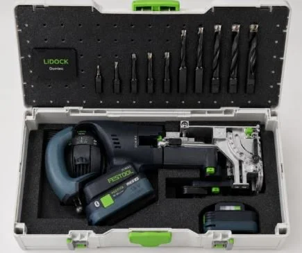 Open toolbox containing cordless drill, various drill bits, a battery pack, and a charger.