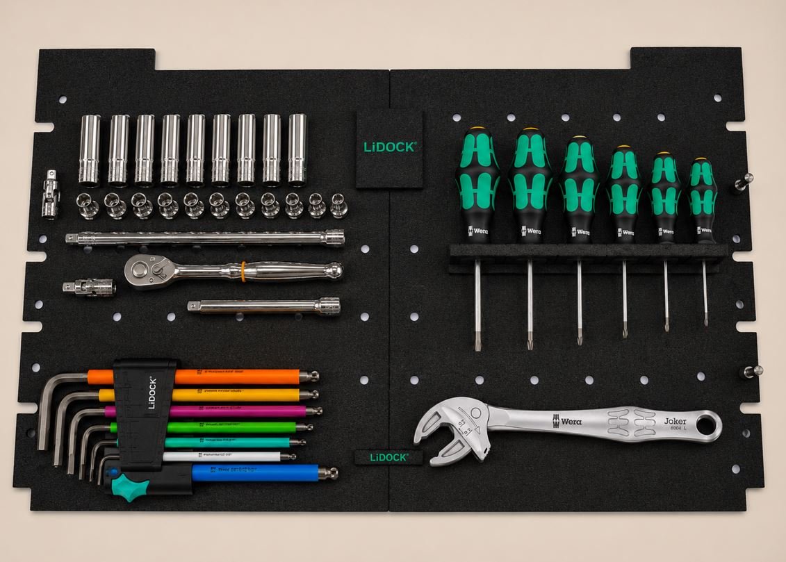 Set of hand tools organized on a black tool board, including sockets, ratchets, screwdrivers, Allen wrenches, an adjustable wrench, and other tools.