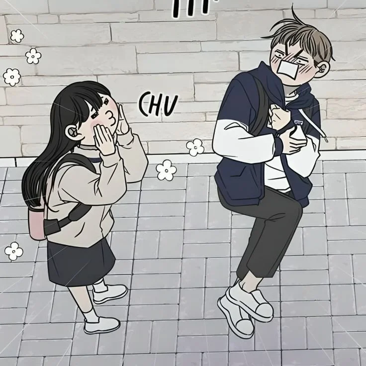 A cartoon illustration of a girl sneezing on a boy's shoulder, who is holding a bottle. The girl has long black hair with bangs and is wearing a beige jacket, black skirt, and white shoes. There are small flowers near her head indicating she is sneezing. The boy has glasses, messy hair, and is wearing a dark jacket, white shirt, gray pants, and white sneakers. The scene appears playful and cute.