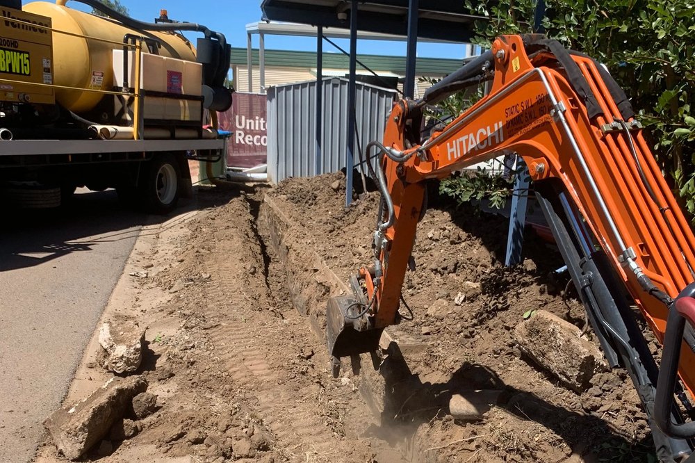 Excavator trenching for underground cabling