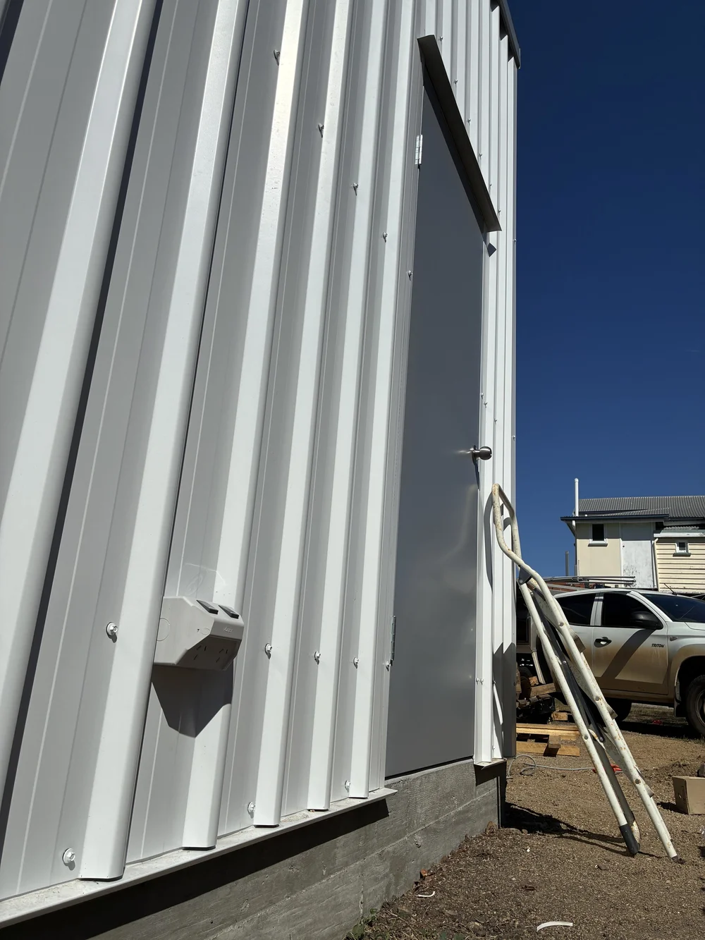 Shed wall with weatherproof electrical fittings