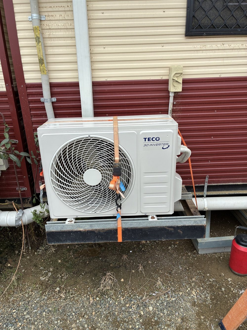 Split system outdoor unit installed on a bracket