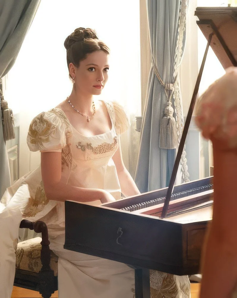 A woman dressed in vintage attire, sitting at a grand piano in a softly lit, elegant room with curtains and classical decor.