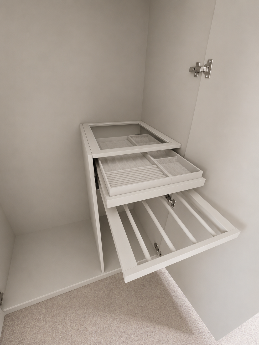 Empty white wardrobe with open drawers and compartments in a closet, with metal hinges visible on the door.