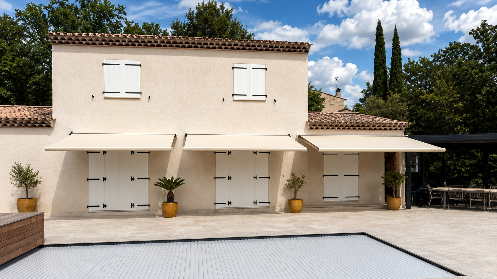 Stores bannes blancs déployés au-dessus des fenêtres d'une villa provençale
