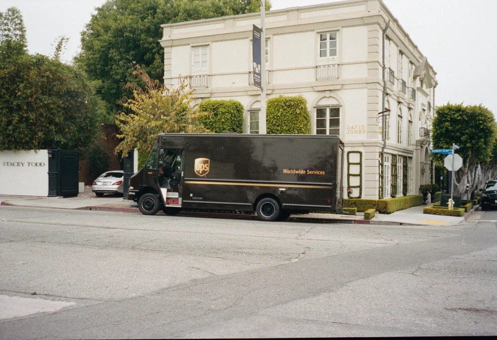 Cine scan sample: a delivery truck outside a white building, with a cinematic colour treatment.