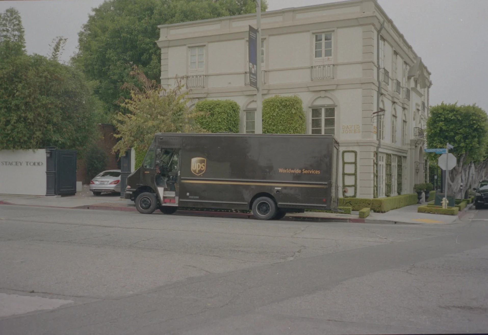 Log scan sample: a delivery truck outside a white building, with flat colour and contrast.
