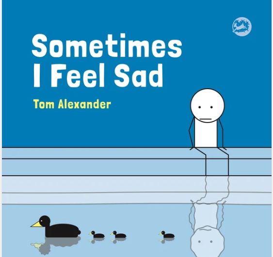 Book cover titled 'Sometimes I Feel Sad' by Tom Alexander, featuring a cartoon sad figure sitting on a dock with a reflection of sadness in the water, with a black duck and ducklings.
