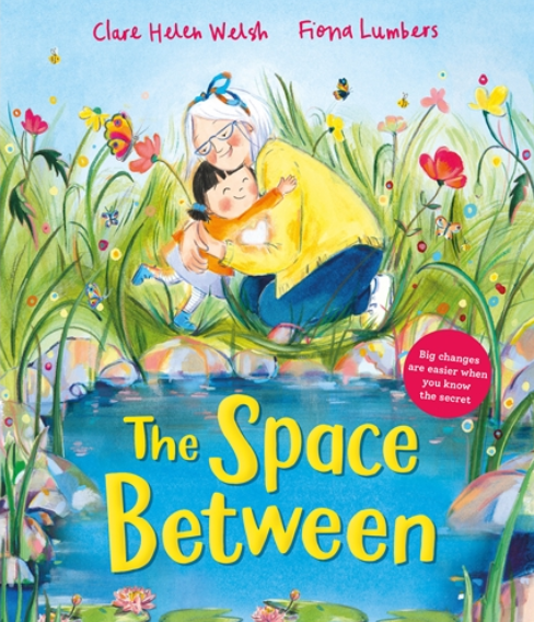 Children hugging a woman near a pond with colorful flowers, grass, and bees, on the cover of a book titled 'The Space Between' by Clare Helen Welsh and Fiona Lumbers.