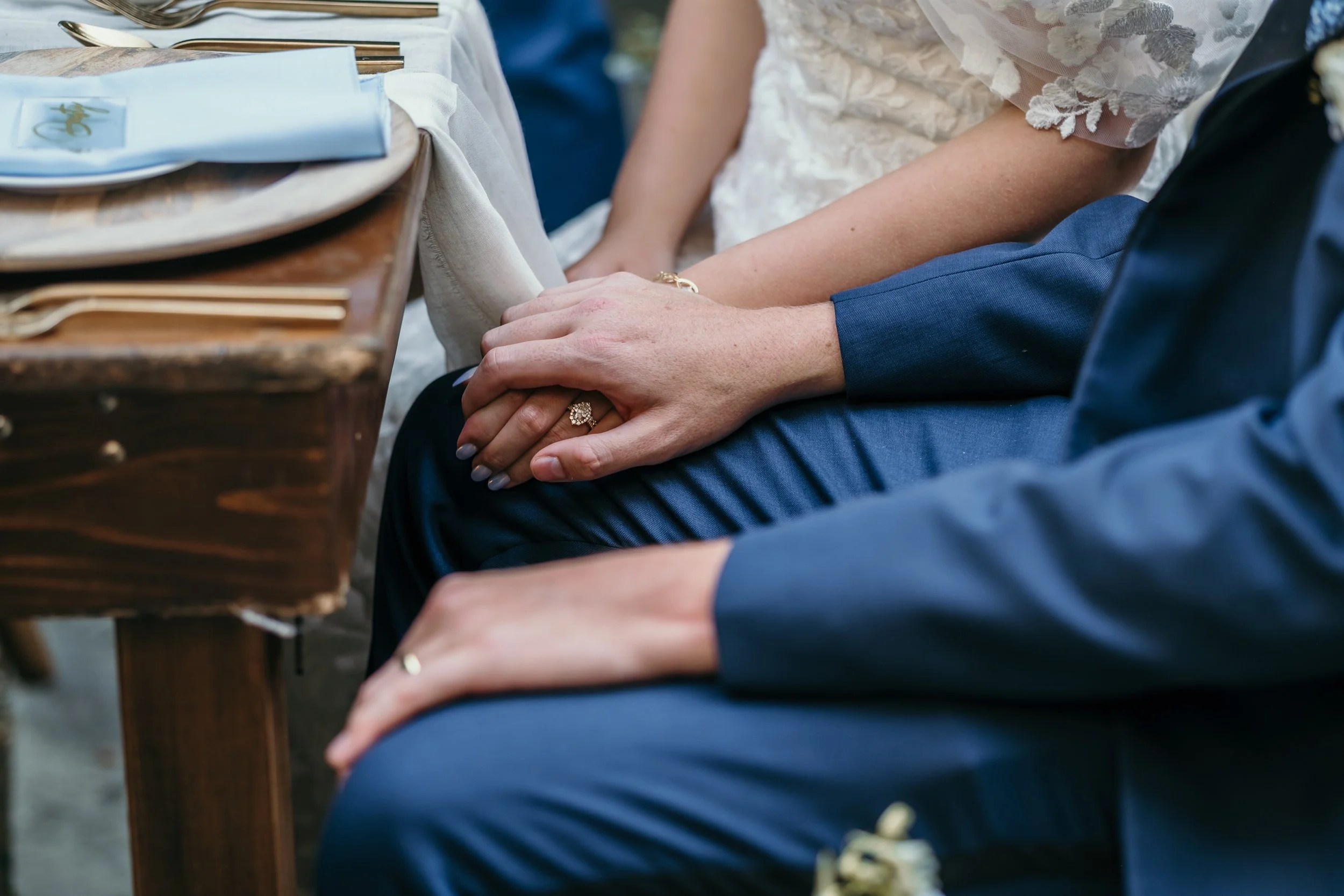 bride and groom hands at dinner