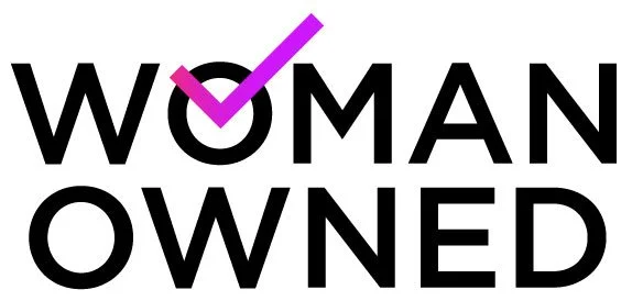 The words "WOMAN OWNED" in bold black text with a purple check mark over the letter 'O' in "WOMAN".