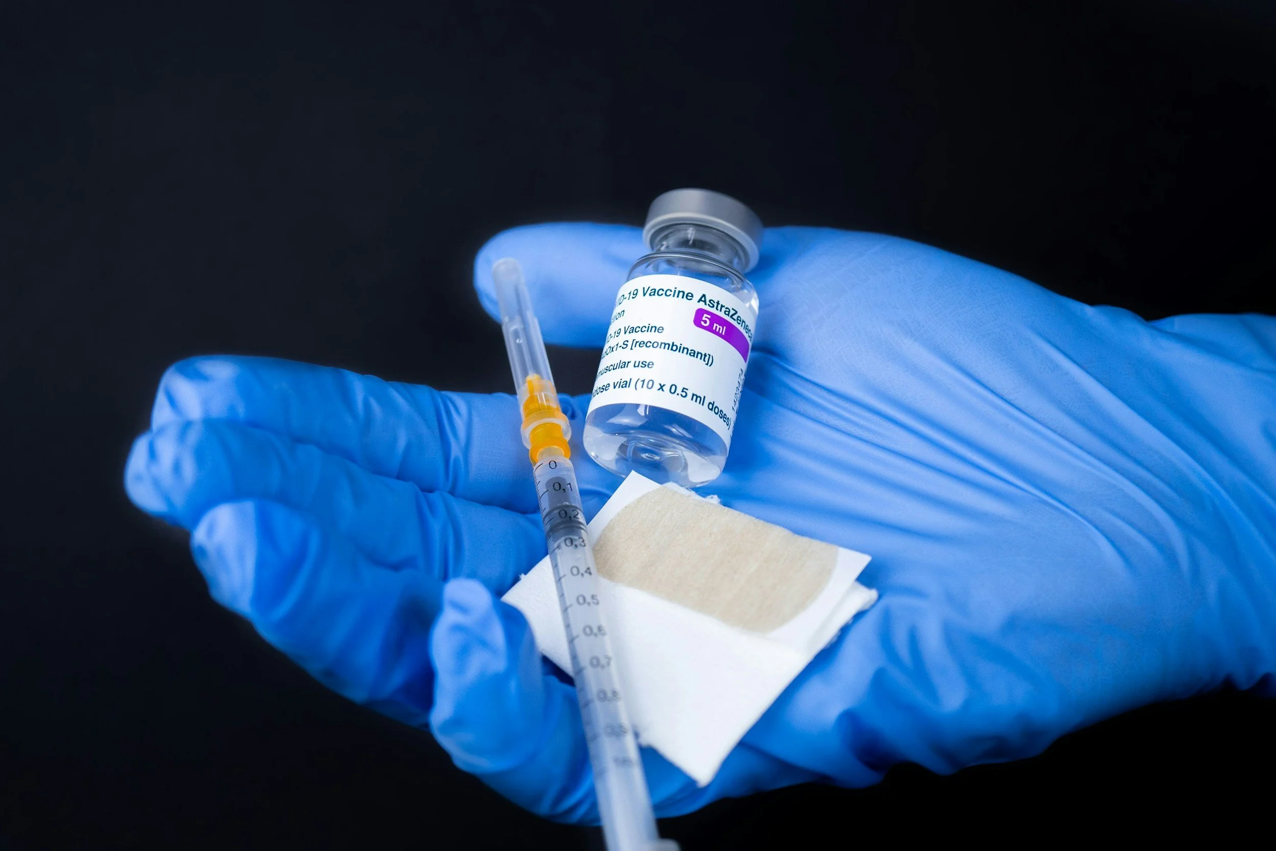 A physician holding a vial of Botox and syringe used for injection to treat chronic migraine, dystonia or spasticity.