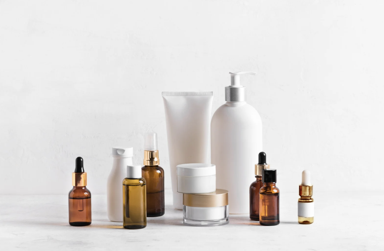 Collection of skincare and beauty products including bottles, jars, and tubes on a white background.