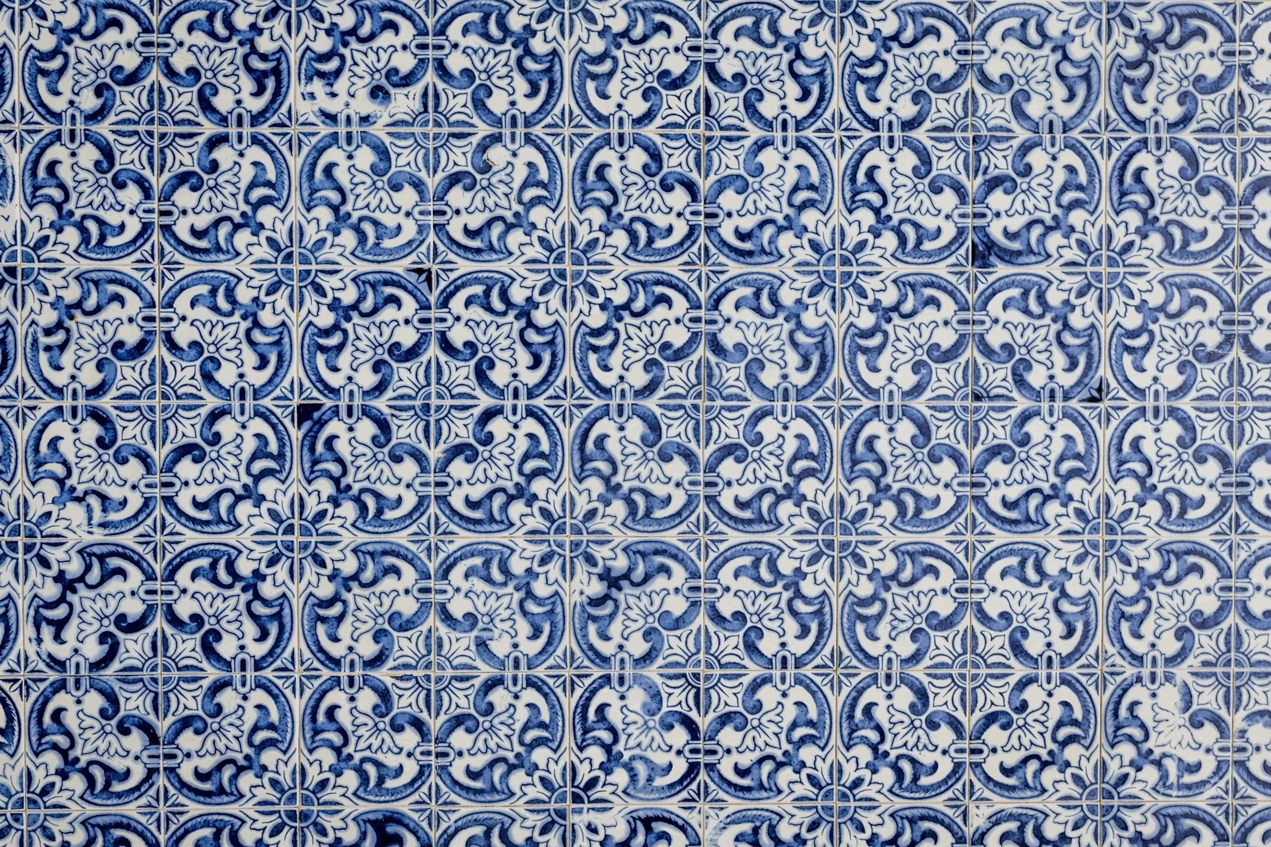 Pattern of blue and white decorative tiles with intricate floral and geometric designs.