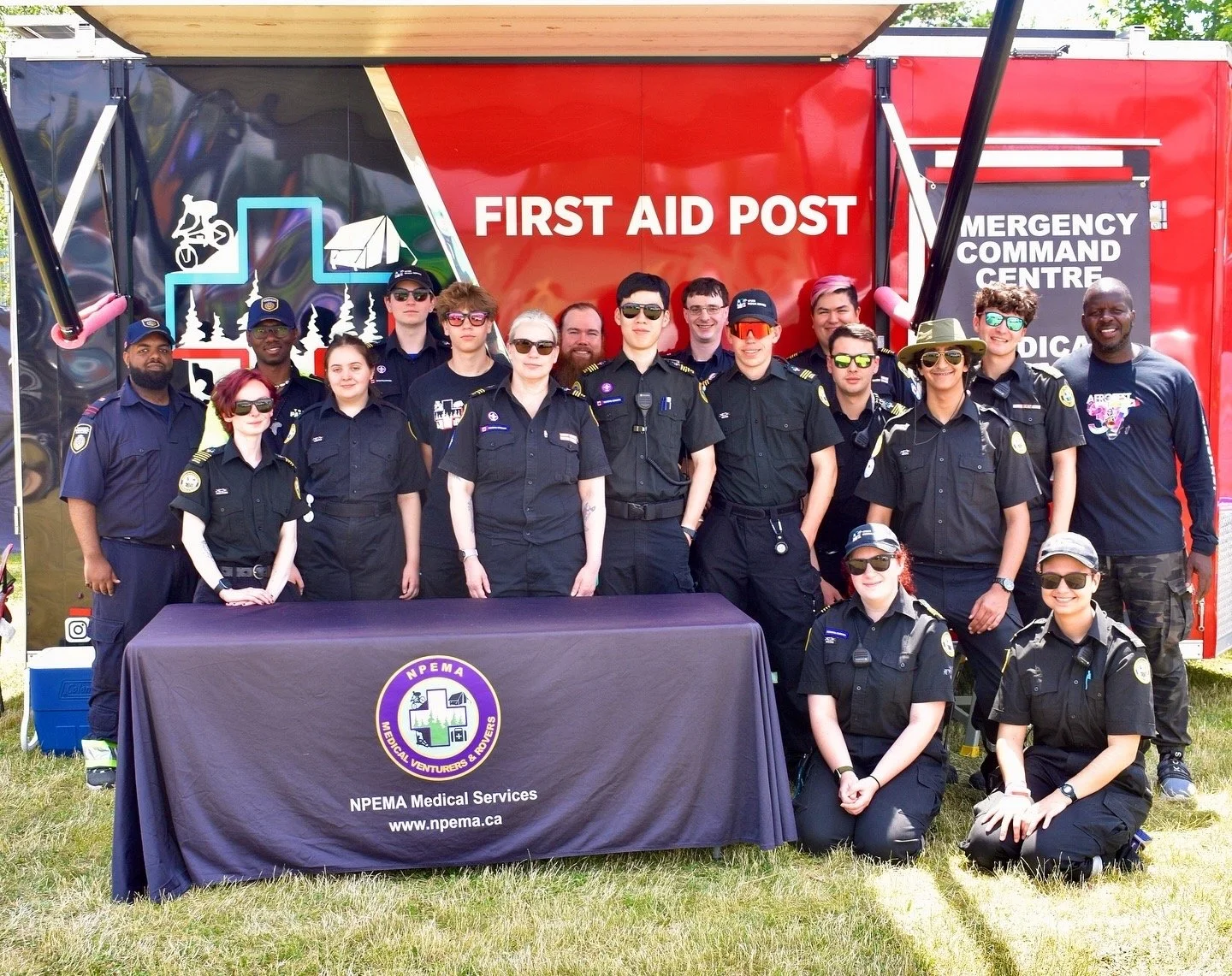 Group photo of NPEMA medical services volunteers in front of a first aid post and emergency command center tent at AfroFest 2026.