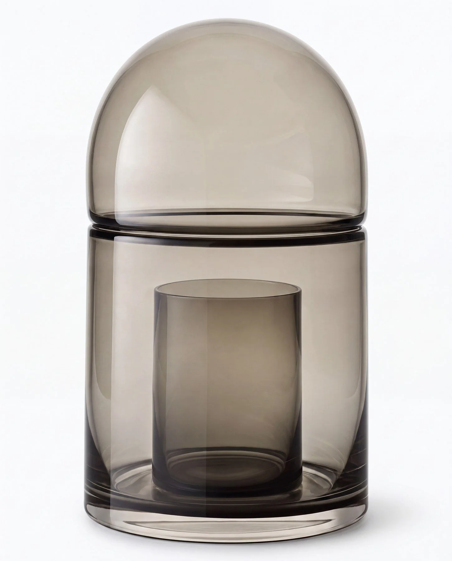 A photo of three sleek, modern, translucent glass containers stacked on top of each other against a white background.
