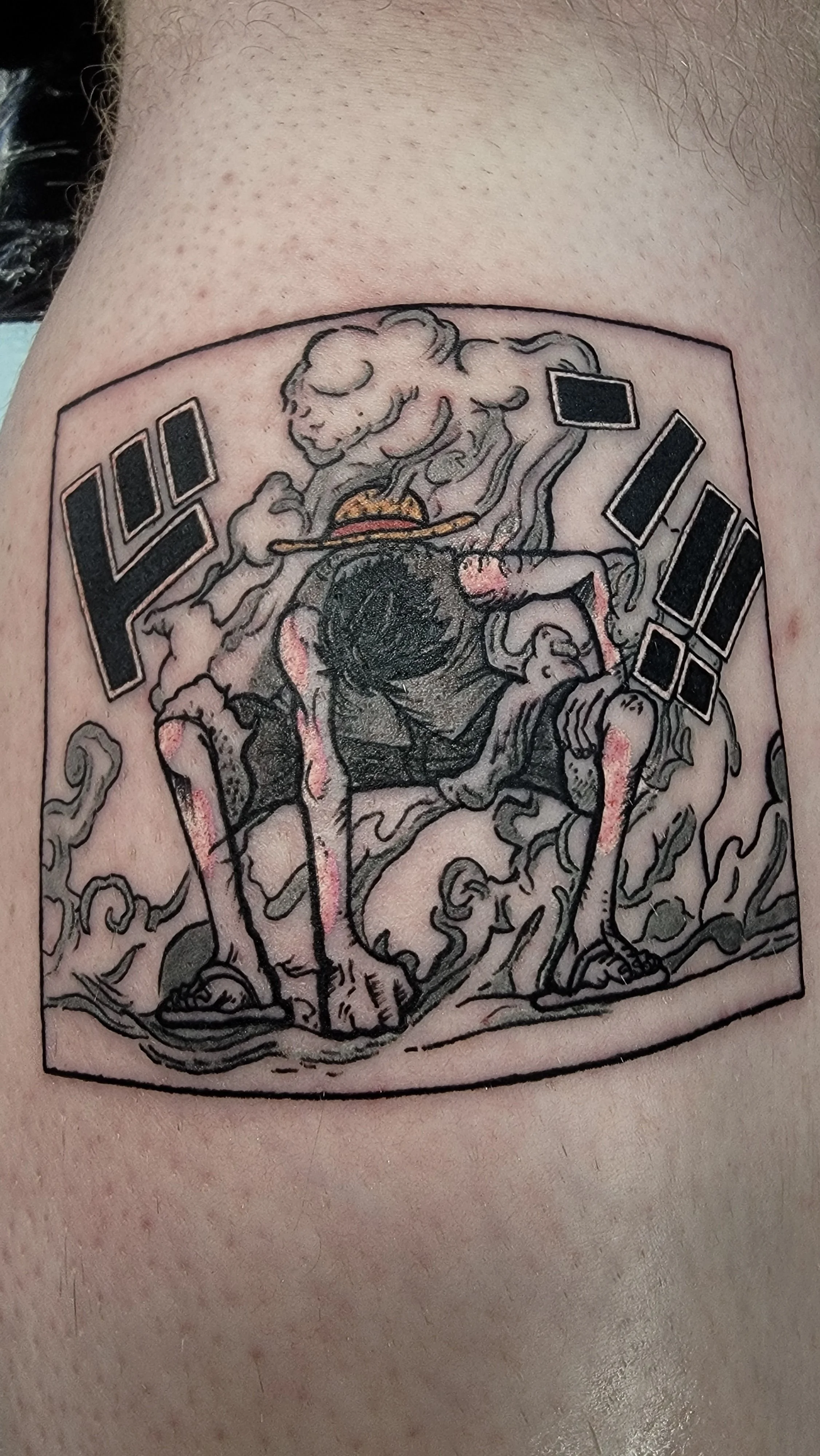 Tattoo of a humanoid creature with a lion's head smoking a cigar, with Japanese characters and exclamation marks beside it.