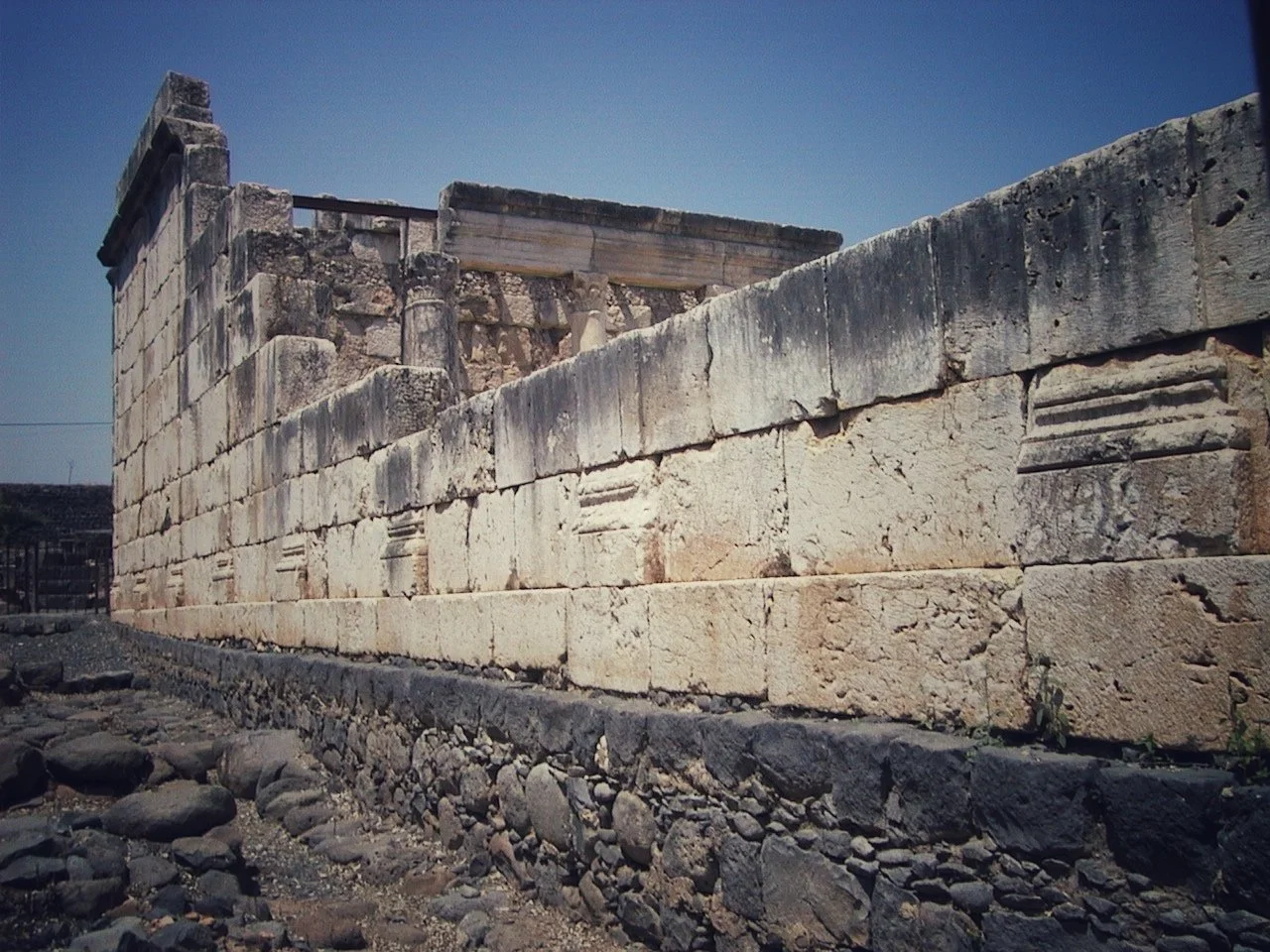 Synagogue at Capernaum. Dark foundation from the time of Jesus. 