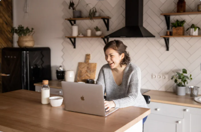 Remote employee working comfortably on a laptop, engaging in a corporate wellness session to prevent workplace burnout.