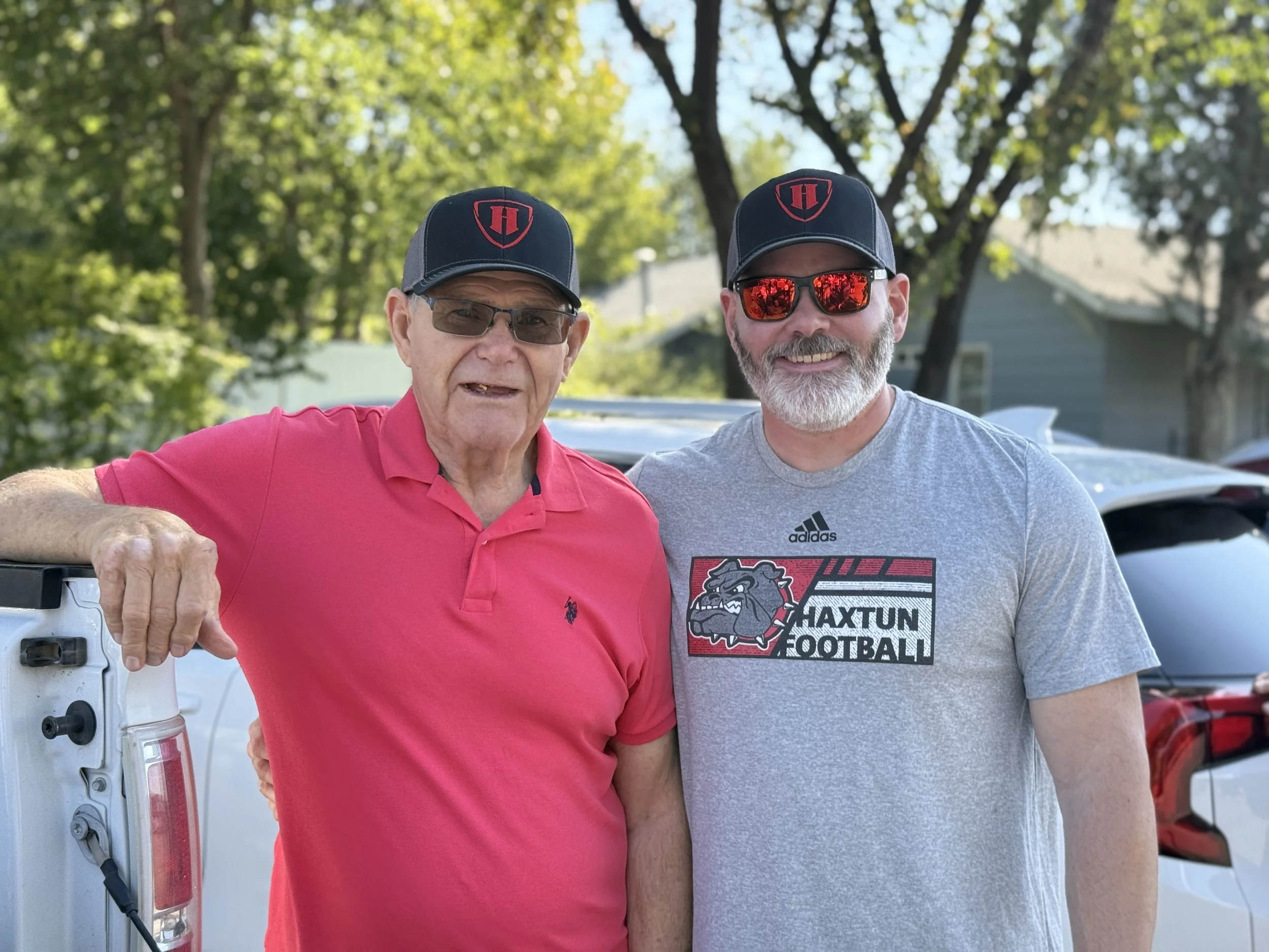 Travis and his dad at Corn Fest representing Haxtun Football.