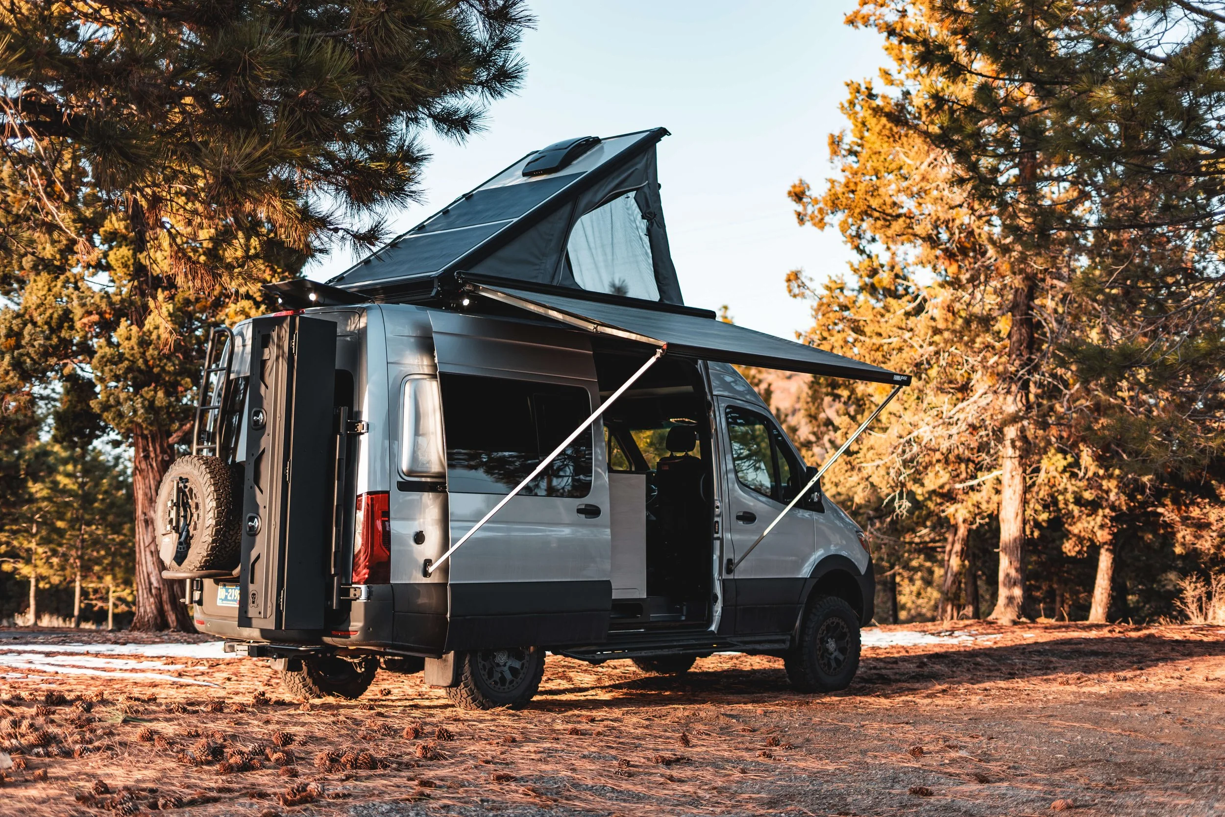 Silver 144 Sprinter van with Super pacific cloud cap tent, fiamma awning, and Owl Vans ski locker