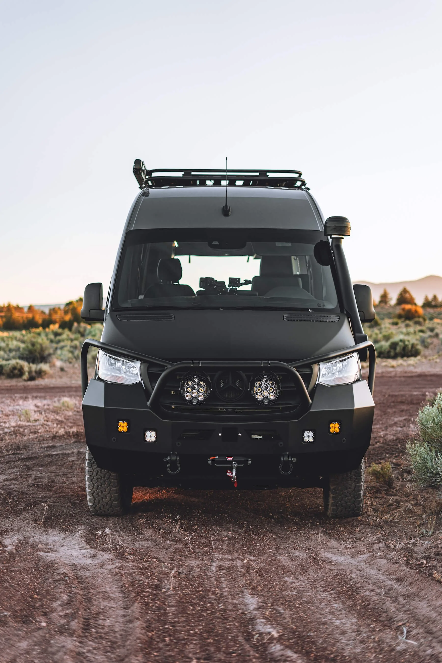 Custom A 170 Sprinter van named 'Choices' with steel bumper, snorkel, and extra lights, photographed at dusk in central Oregon.