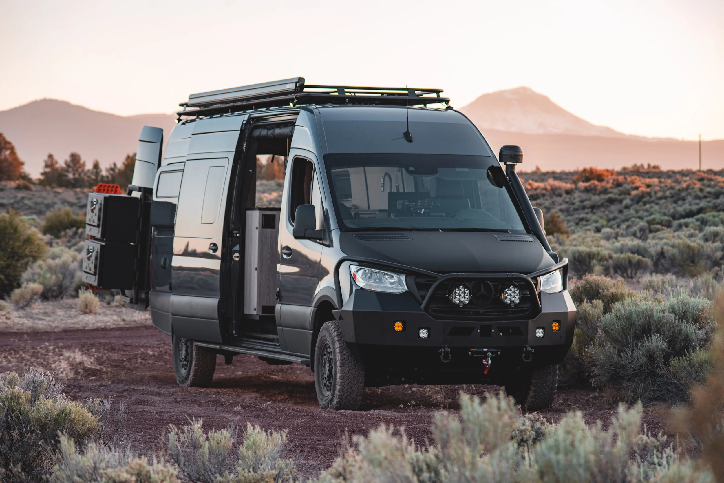 Sprinter 170 with open sliding and rear doors, captured in Central Oregon near Bend with South Sister mountain in the background.