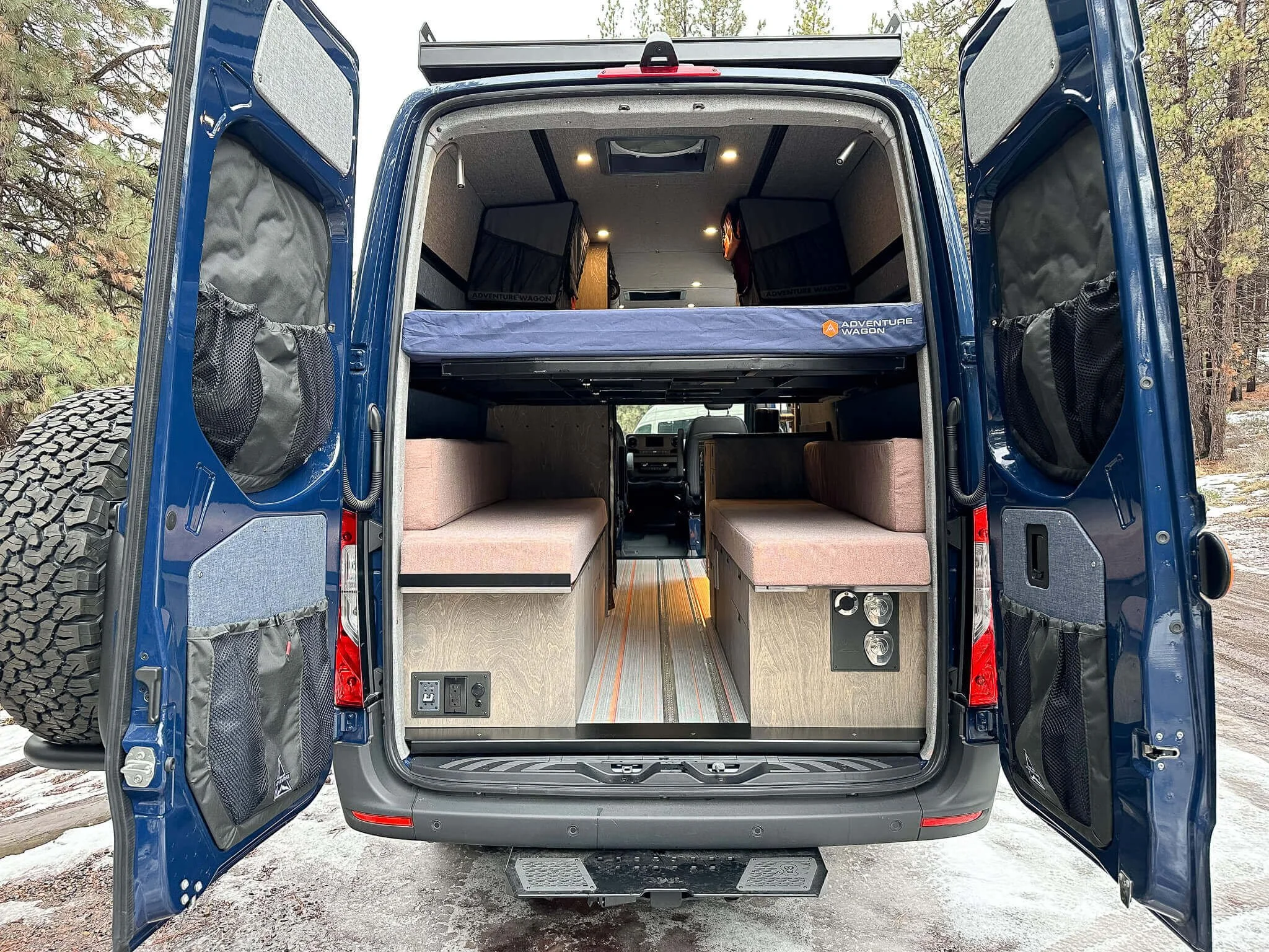 Rear doors open on 'Chuck Wagon' van, revealing custom HWA interior from rear view.