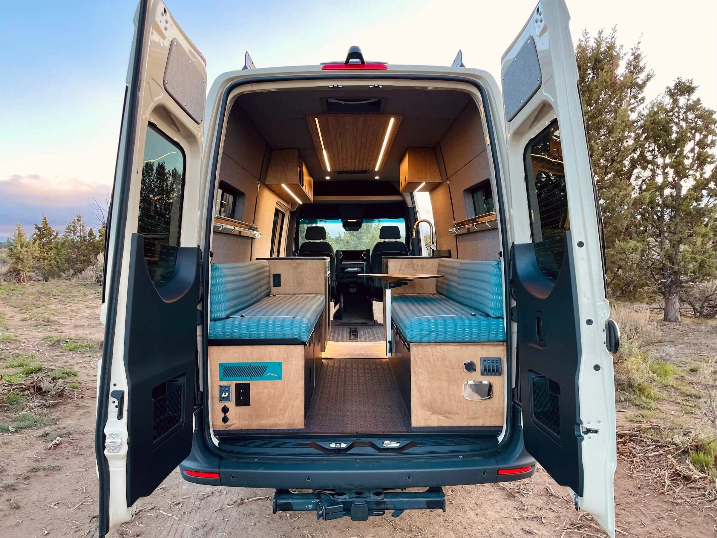Custom HWA interior of 'Funner' Sprinter 170 van displayed with rear doors open
