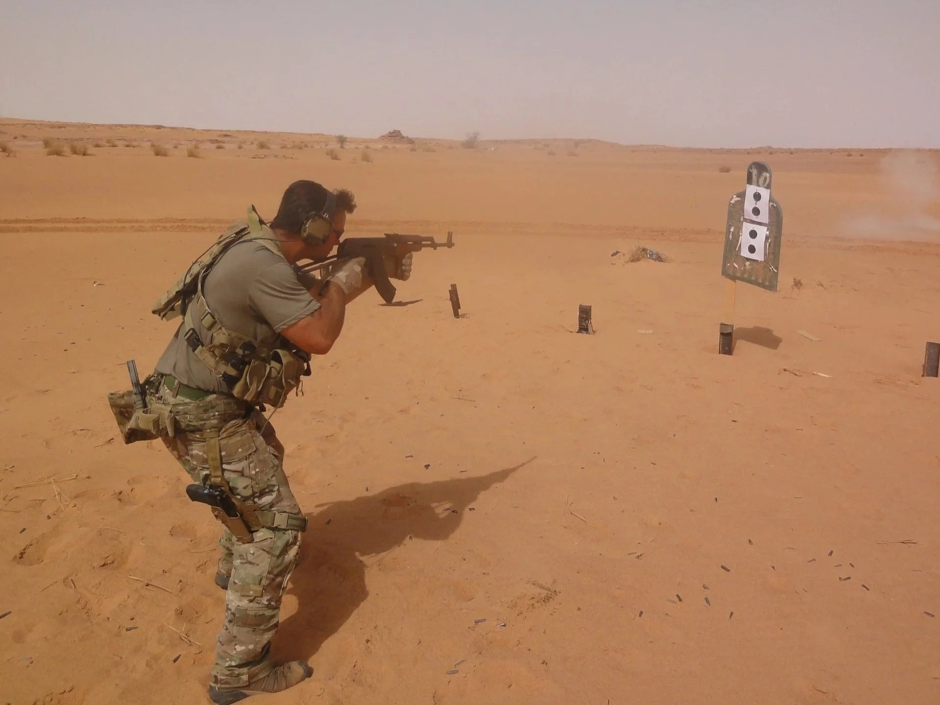 Robb Milheim firing an AK-pattern rifle while cross training on foreign weapons in Africa with US Army Special Forces