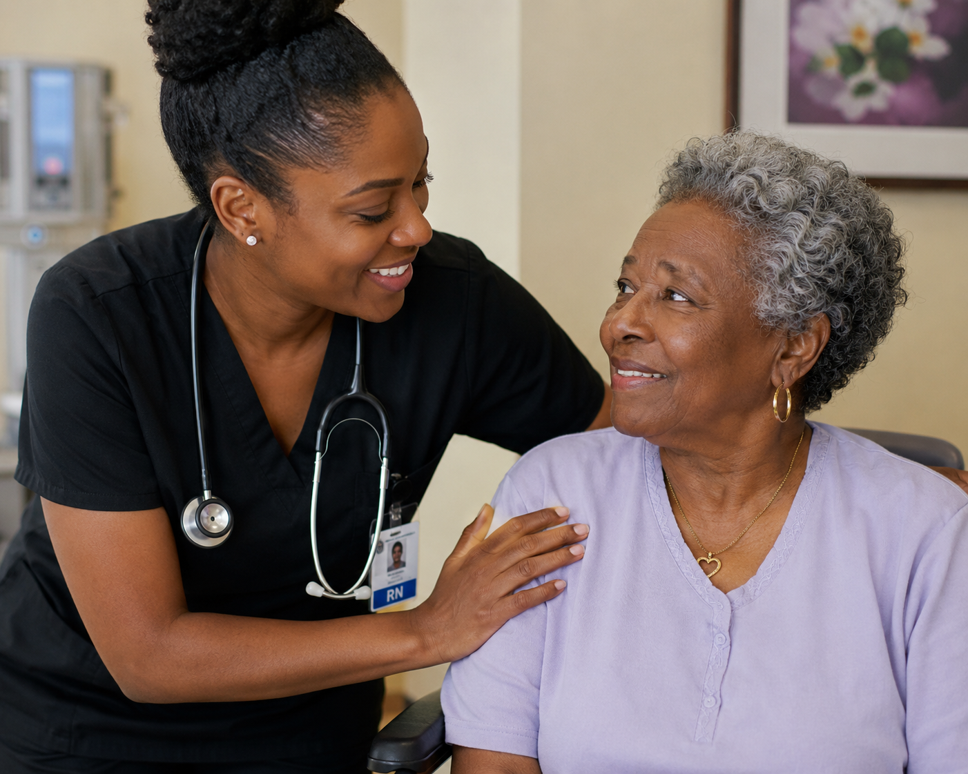 A healthcare worker, wearing black scrubs and a stethoscope, smiling and comforting an elderly woman with gray hair, who is sitting in a chair and looking up at her.