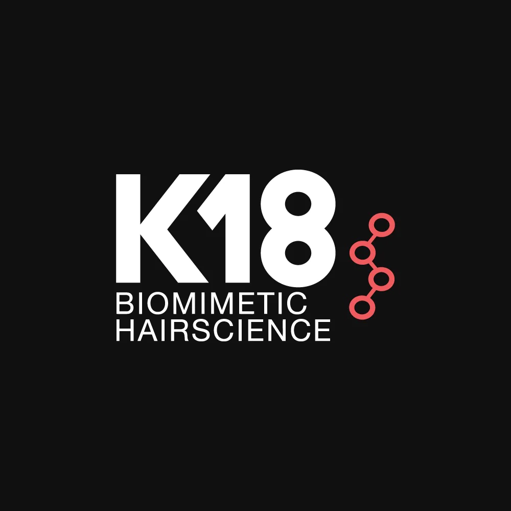 Black background with white text displaying 'K18' and 'BIOMIMETIC HAIRSCIENCE', with a small pink molecular structure graphic beside it.