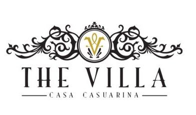 Logo for The Villa Casa Casurina featuring an ornate black and gold decorative crest and the text 'The Villa Casa Casurina'.