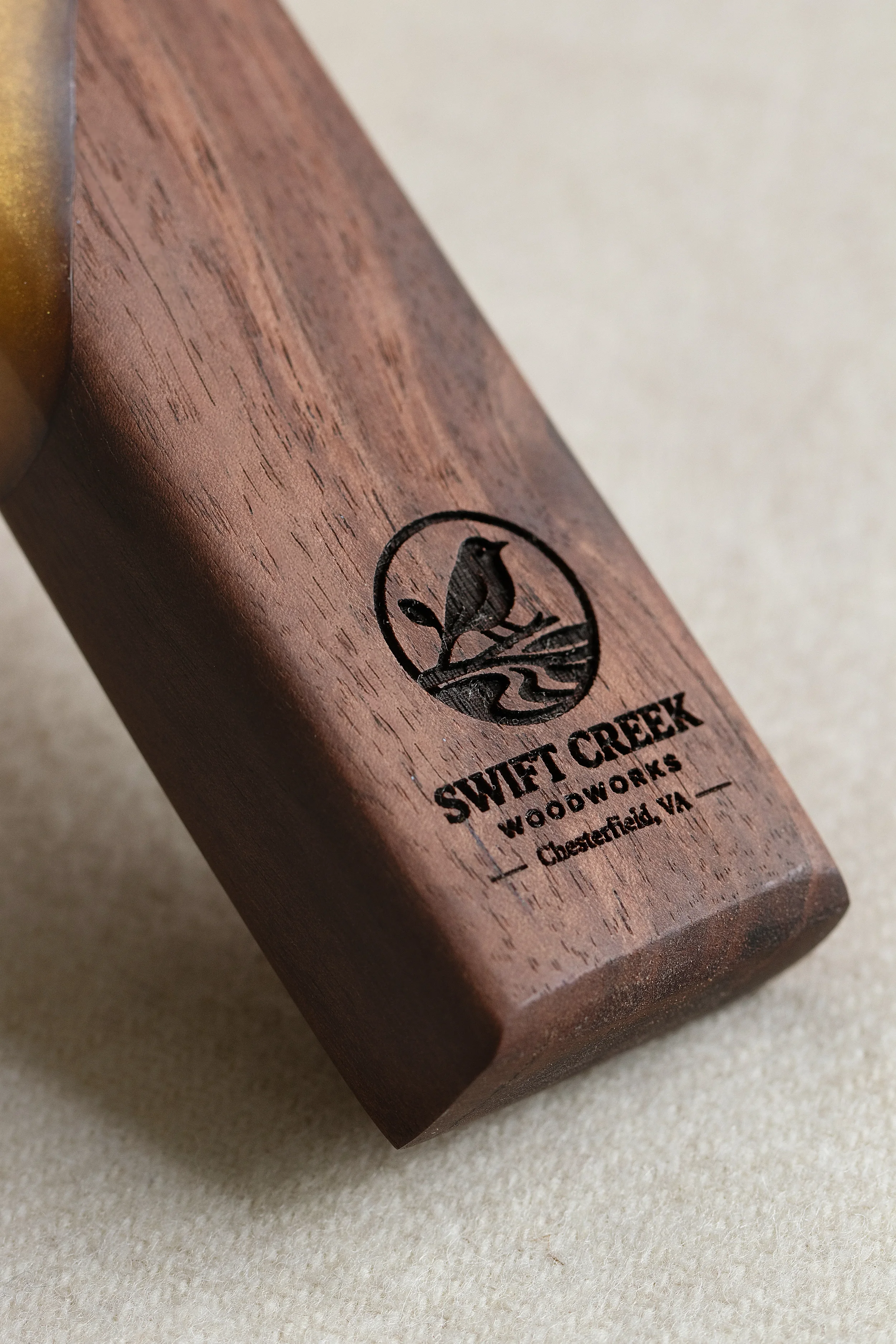 Wooden mallet with a logo of a bird and the text "Swift Creek Woodworks, Chesterfield, VA" engraved on it.