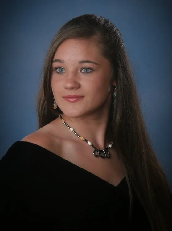 Portrait showing the V-neckline of a black velvet senior drape