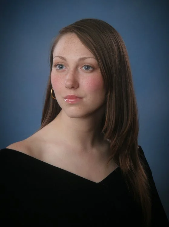 High school senior wearing a black velvet V-neck portrait drape