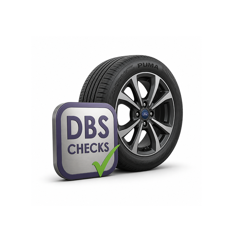 A car tire with Ford logo and a DBS Checks sign next to it.