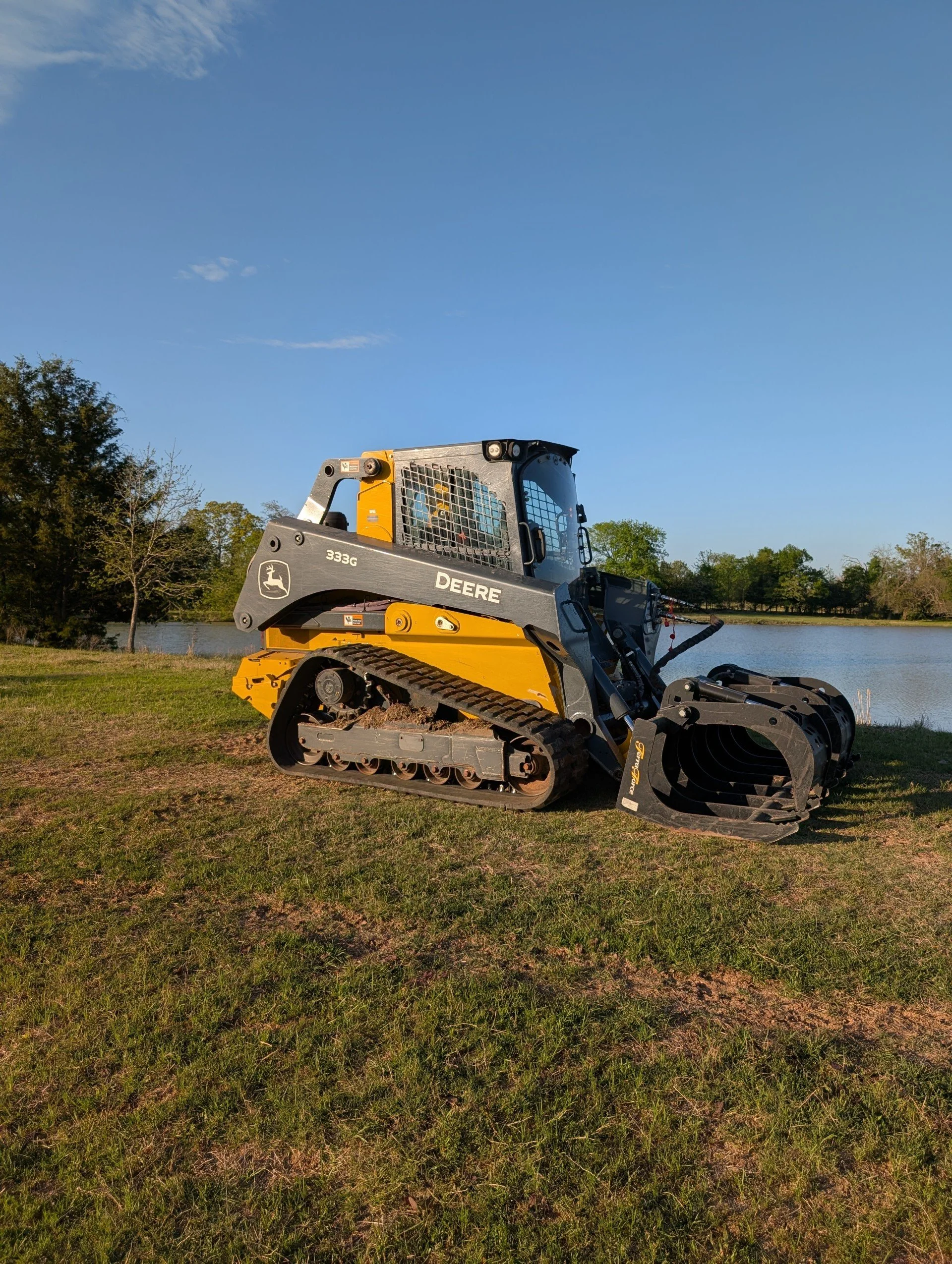 John Deere compact track loader with mulching head used by Rustin Land Management for forestry mulching and land clearing jobs near Sherman, TX and Grayson County.