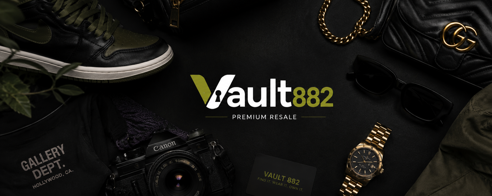 Flat lay of various fashion accessories and items surrounding the Vault 882 logo, including a black and green Nike sneaker, black sunglasses, a gold watch, a black quilted Gucci purse with gold hardware, a Canon camera, a black Vault 882 card, and part of a green jacket, all on a black background.