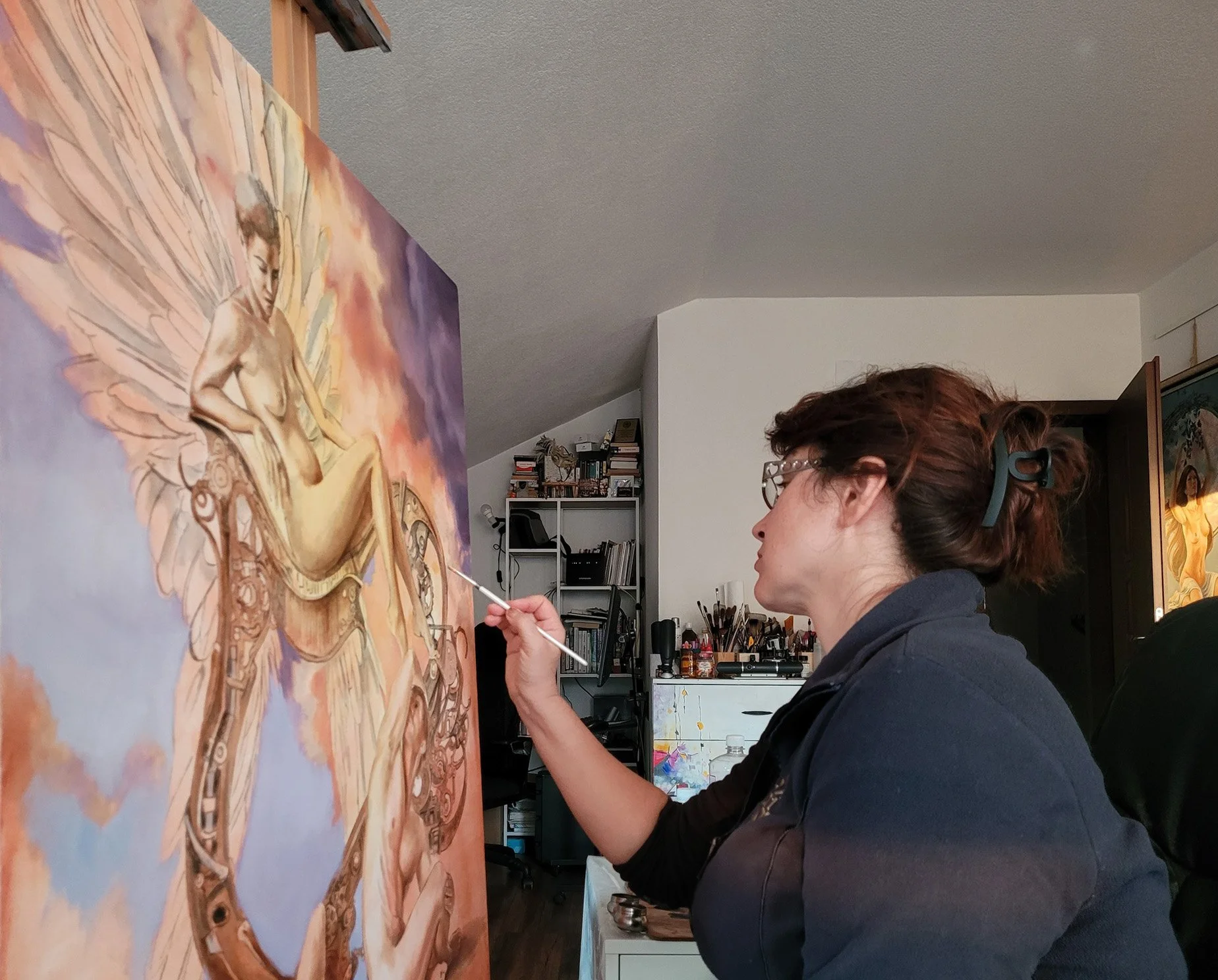 Nika Nyoko working on a large figurative oil painting in her studio.