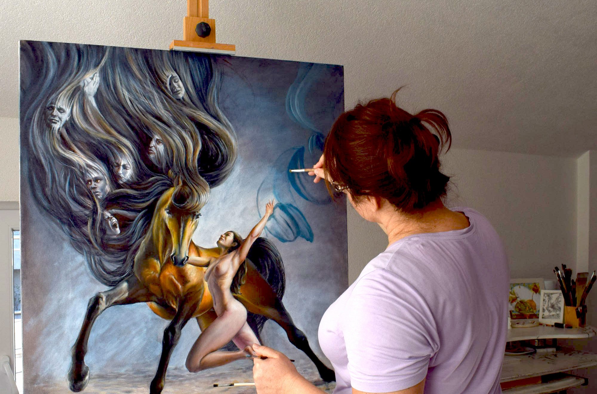 Nika Nyoko painting an oil artwork in her studio.