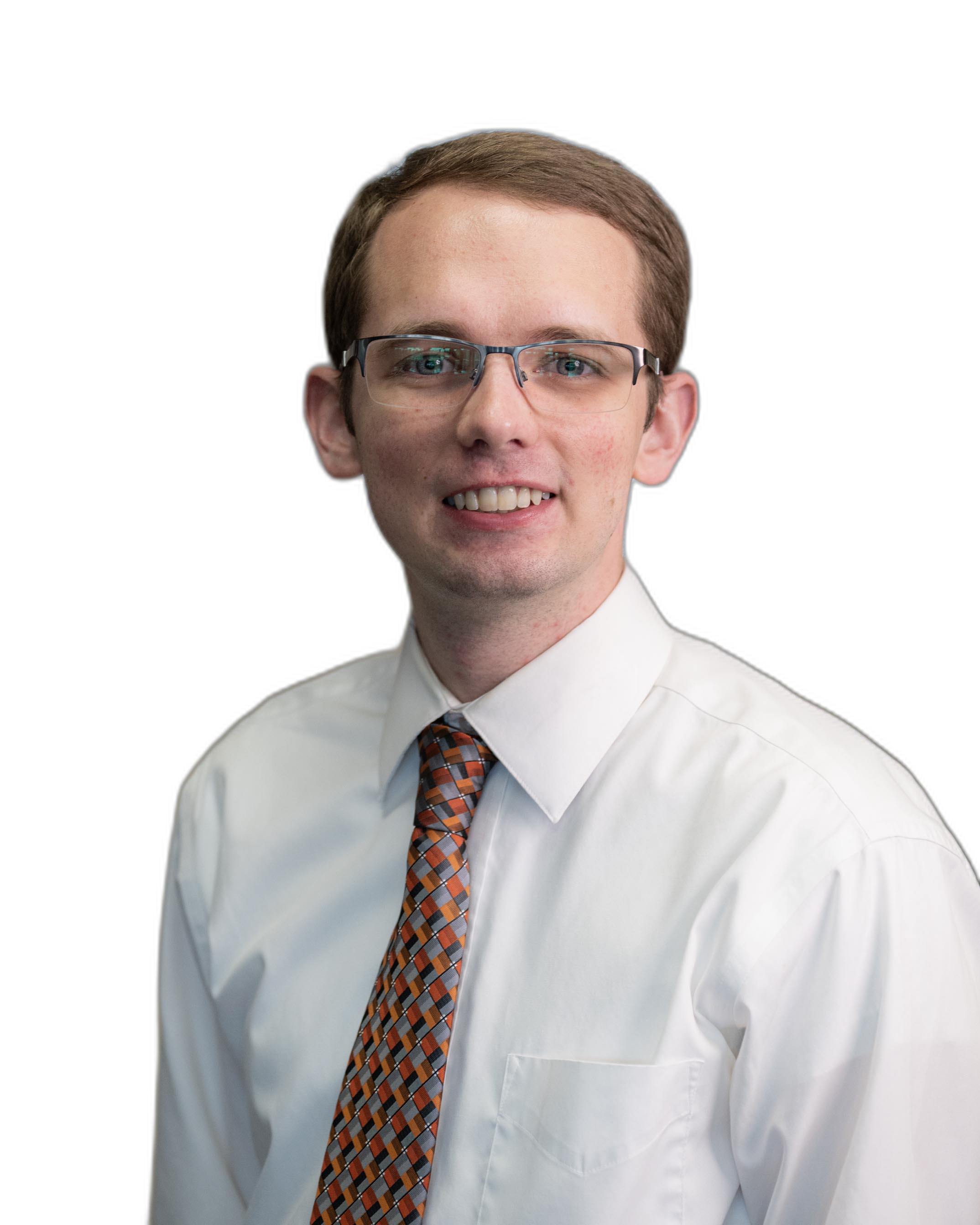 Portrait of a young man with light brown hair, wearing glasses, a white dress shirt, and a patterned tie, smiling with teeth showing against a black background.