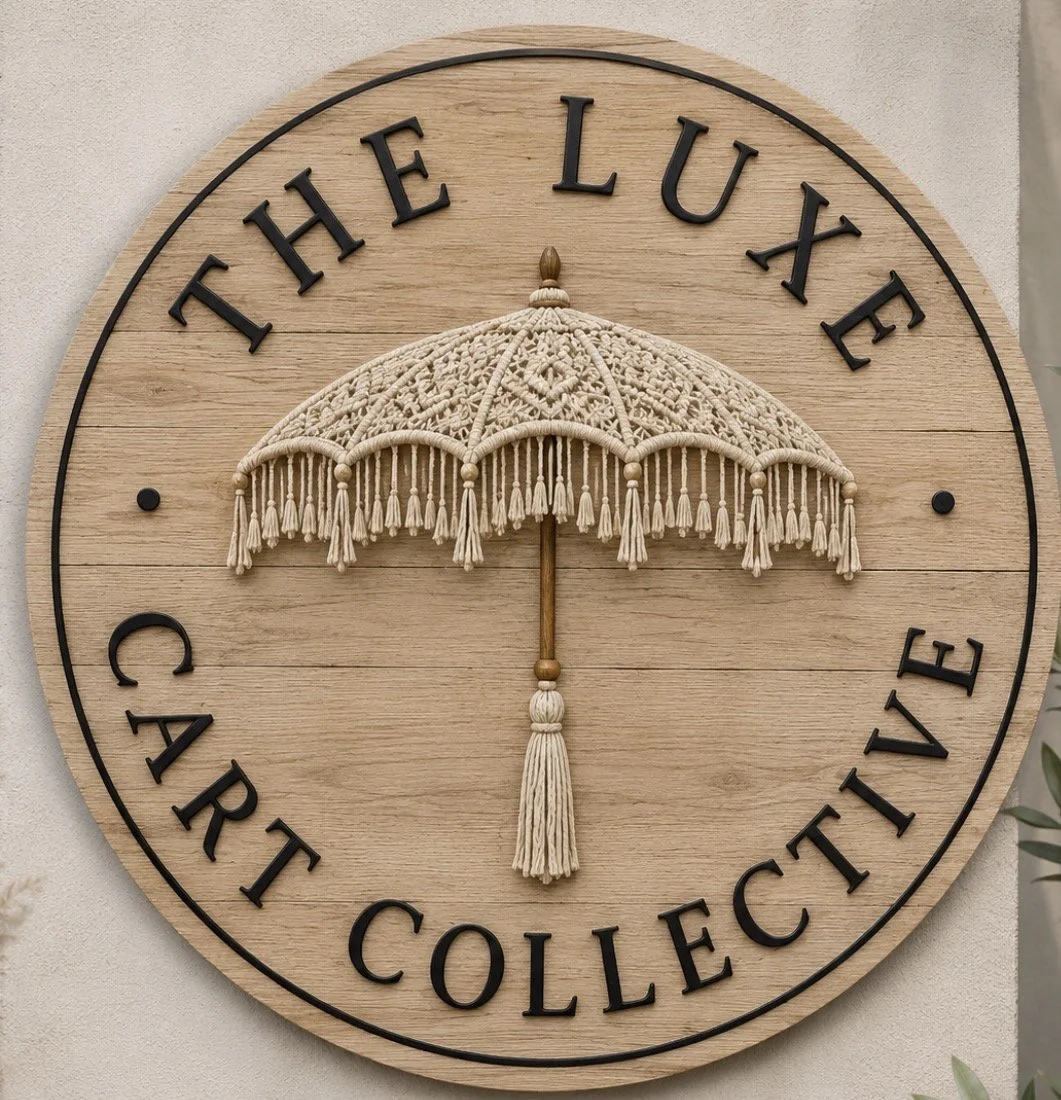 Decorative wall clock with the words "The Luxe Art Collective" and a macrame umbrella in the center.